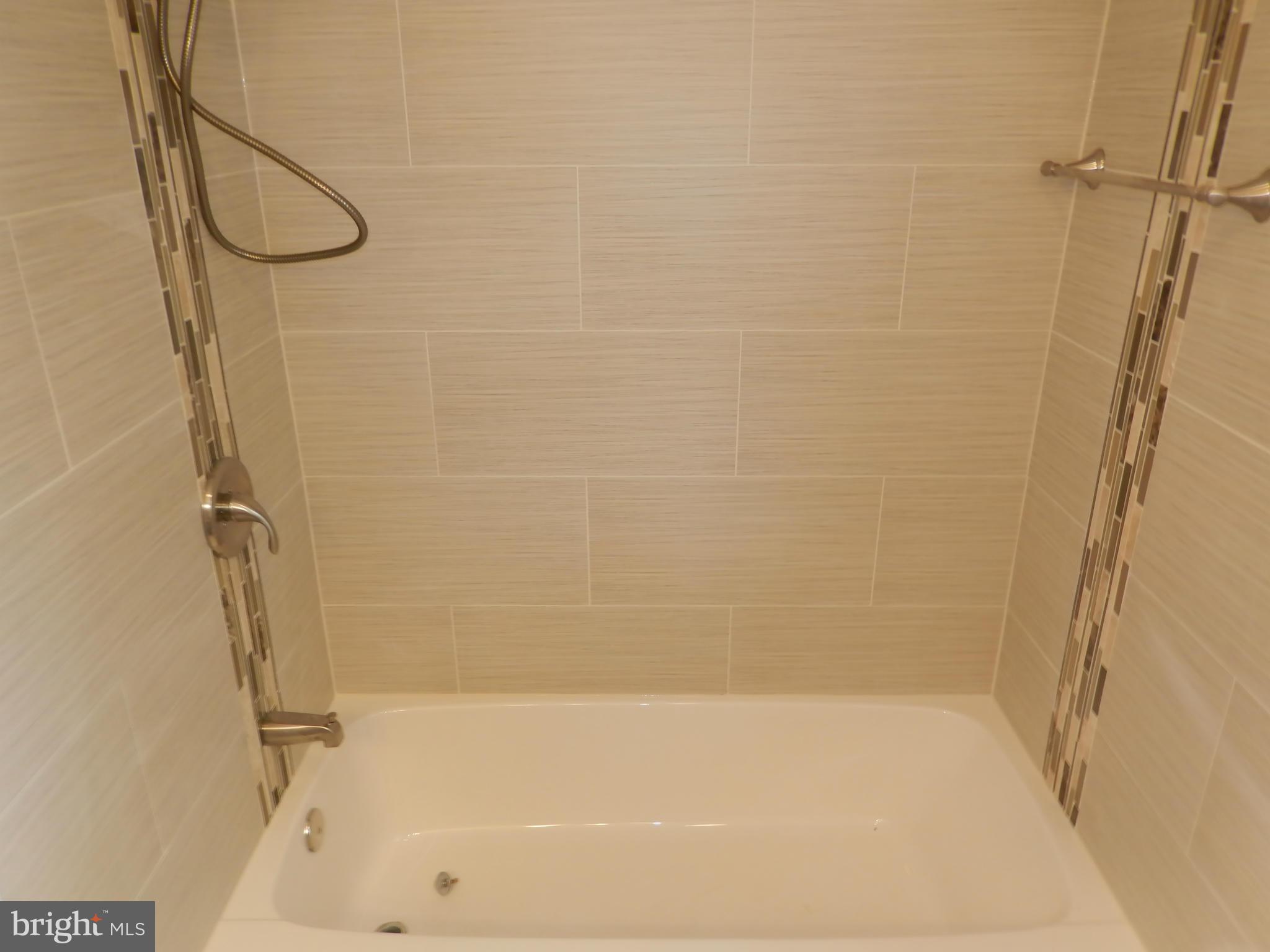 622 Charraway Road Baltimore, MD 21229 - Photo 21 of 28 a bathroom with a bath tub with a shower