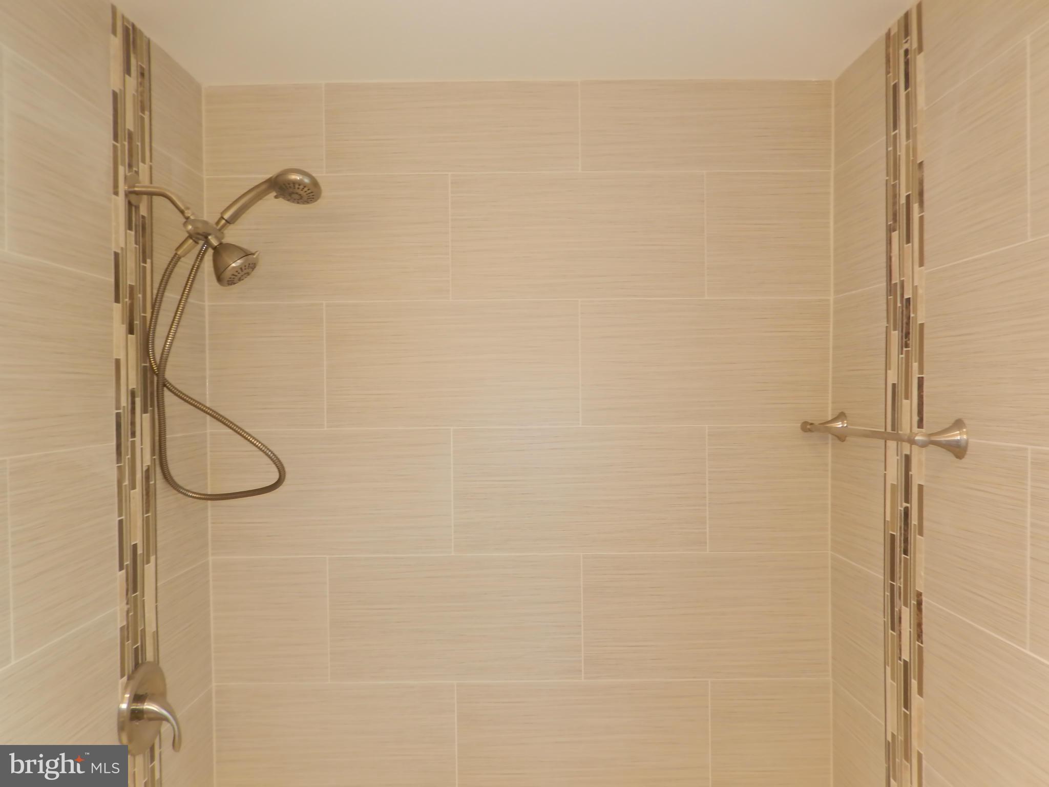 622 Charraway Road Baltimore, MD 21229 - Photo 22 of 28 a bathroom with a glass shower door