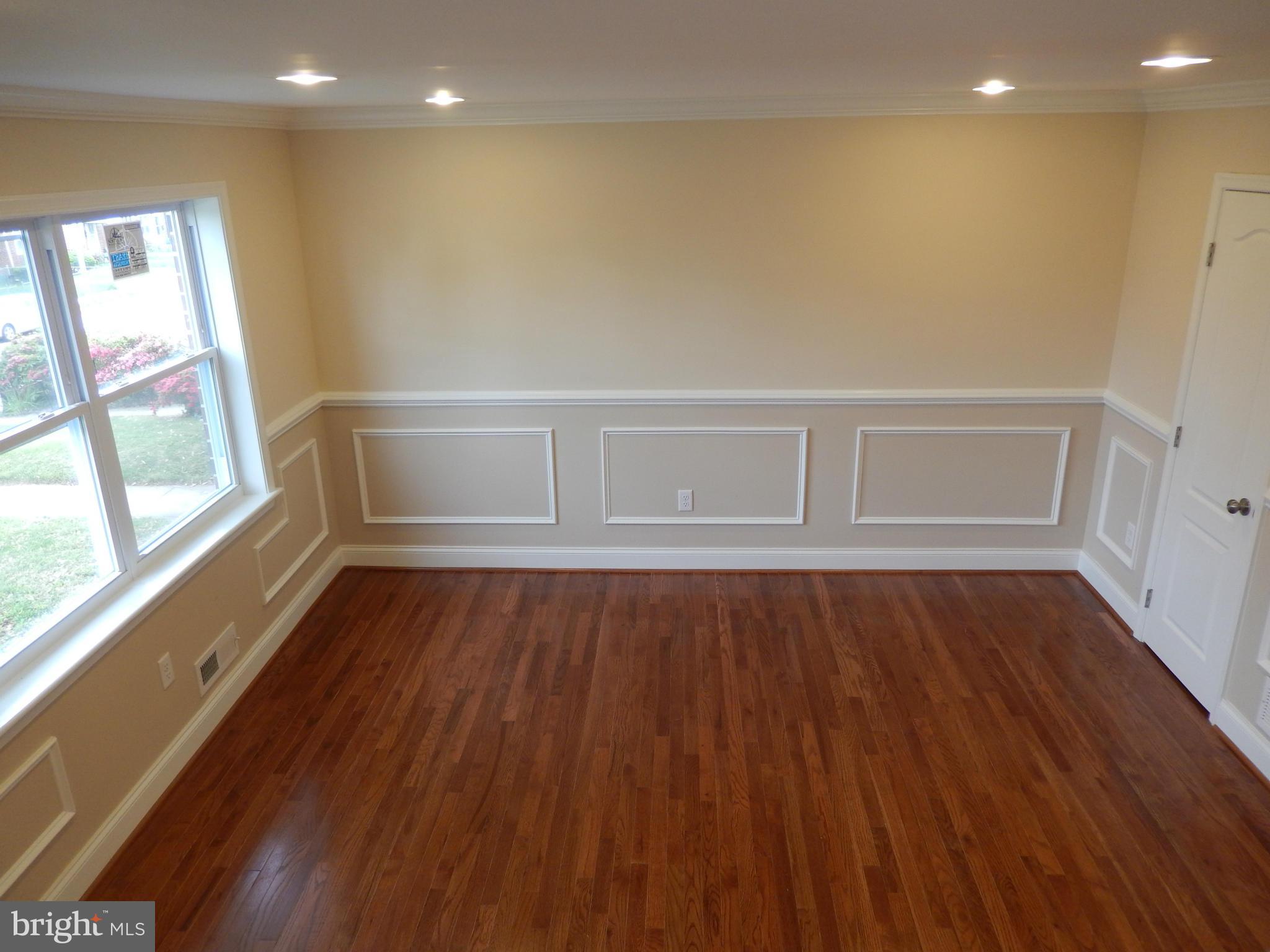 622 Charraway Road Baltimore, MD 21229 - Photo 4 of 28 a view of an empty room with wooden floor and window