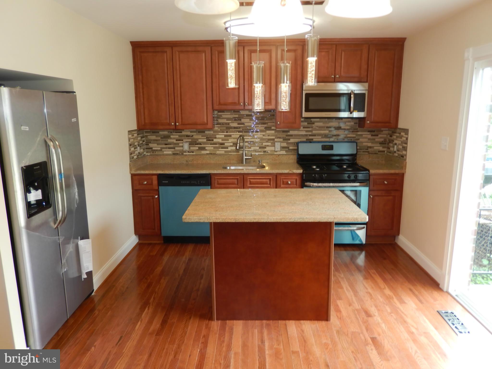 622 Charraway Road Baltimore, MD 21229 - Photo 9 of 28 a kitchen with a sink appliances and cabinets