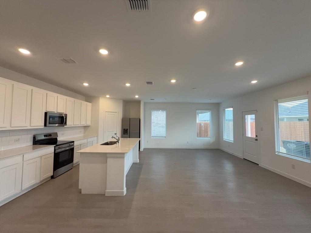 537 Ml Trce Way Princeton, TX 75407 - Photo 3 of 40 a kitchen with kitchen island a sink stainless steel appliances and cabinets