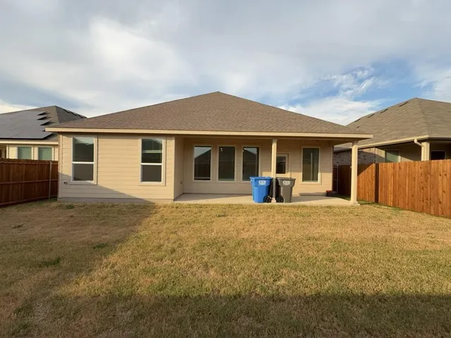 a view of a house with backyard and porch