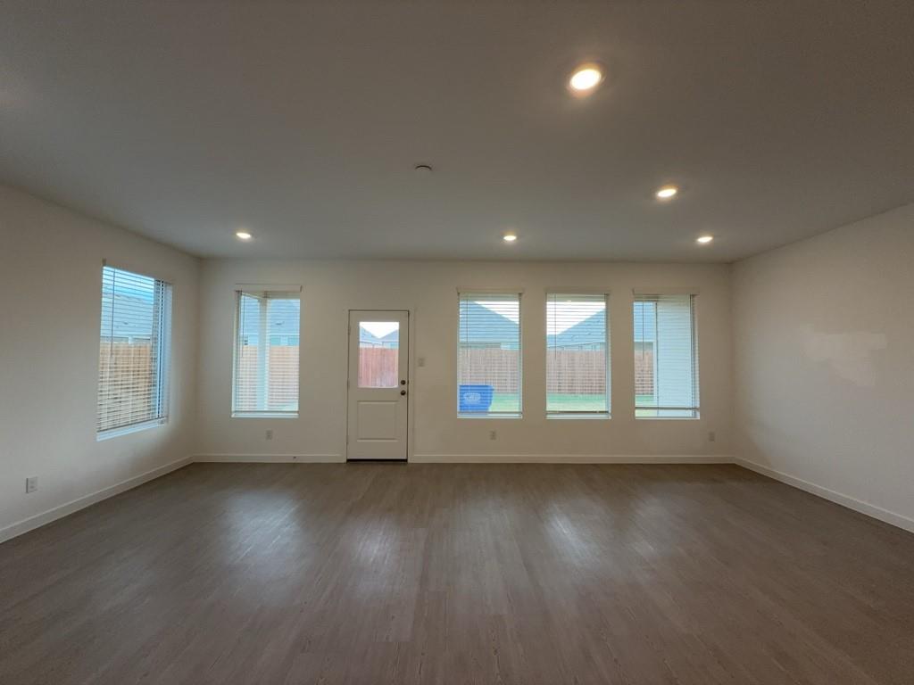 537 Ml Trce Way Princeton, TX 75407 - Photo 7 of 40 an empty room with wooden floor and windows