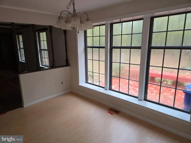 a view of a hallway with windows and entryway