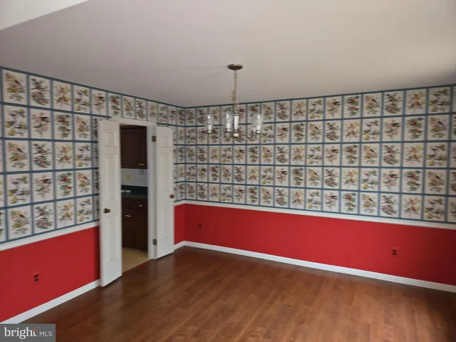 a view of wooden floor and windows in a room