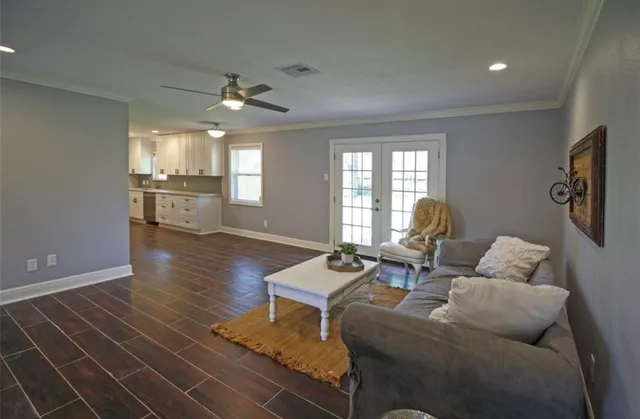 a living room with furniture and a wooden floor