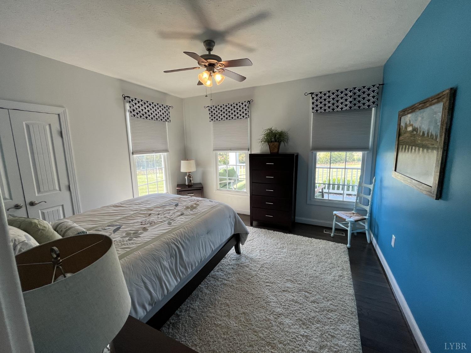 1959 Founding Way Road Goode, VA 24556 - Photo 22 of 65 a bedroom with a bed and a chandelier