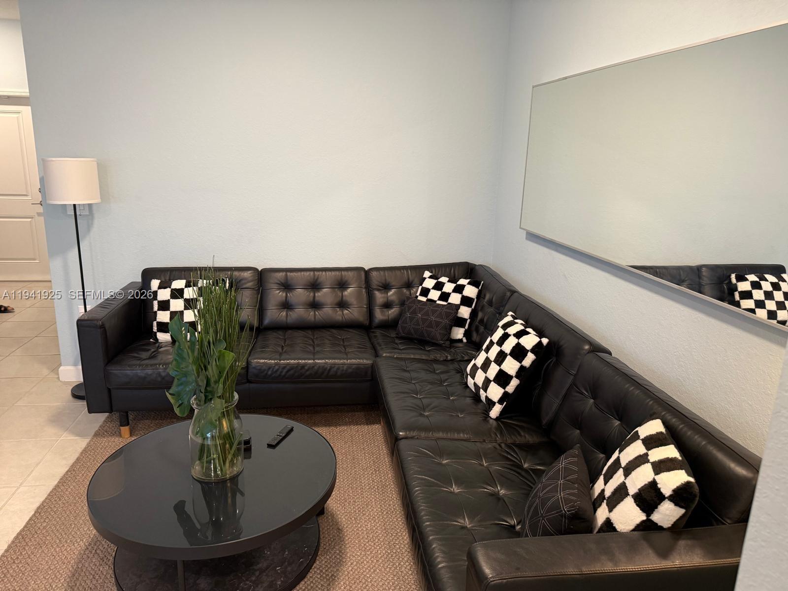 887 Northeast 211th Street Miami, FL 33179 - Photo 11 of 25 a living room with furniture and flowers