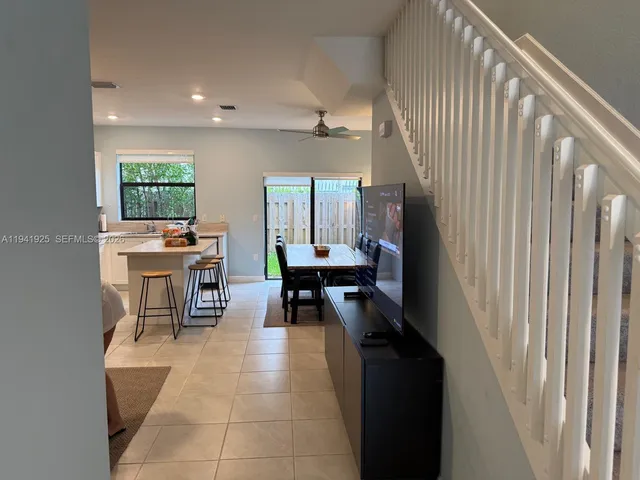a living room with furniture a window and a table