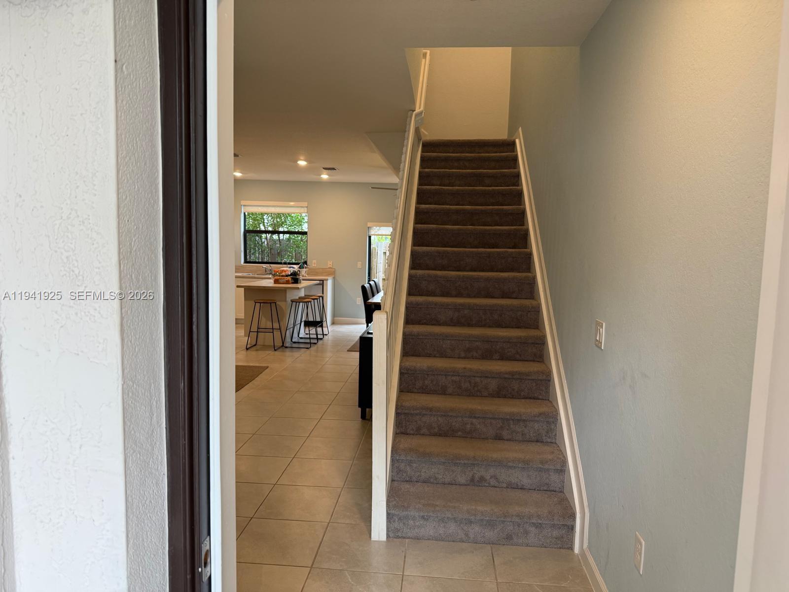 887 Northeast 211th Street Miami, FL 33179 - Photo 13 of 25 a view of entryway and hall with wooden floor