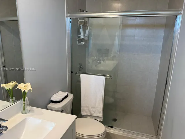 a bathroom with a sink toilet and shower