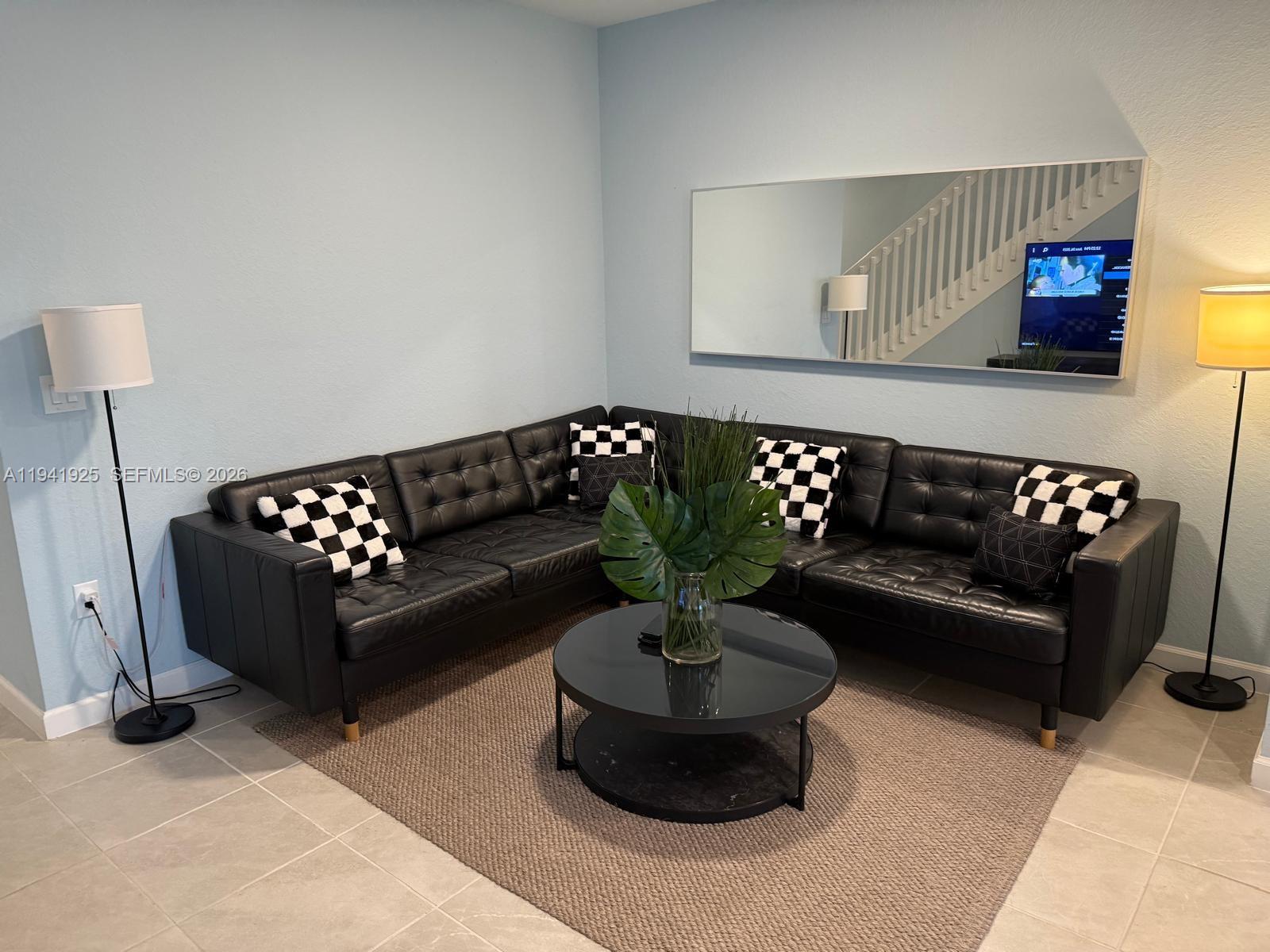 887 Northeast 211th Street Miami, FL 33179 - Photo 10 of 25 a living room with furniture and a potted plant