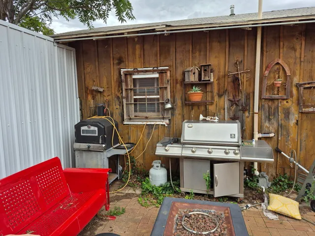 a backyard of a house with table and chairs