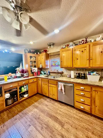 a large kitchen with stainless steel appliances granite countertop a large stove a sink dishwasher and a microwave oven with large wooden cabinets