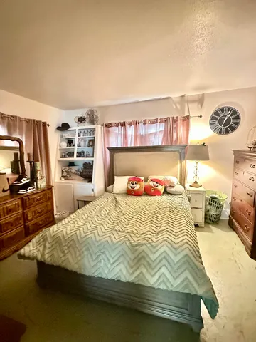 a bedroom with a bed and a table
