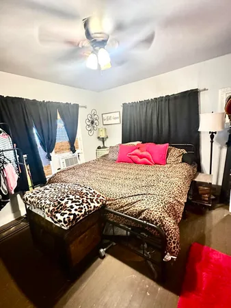 a bedroom with a bed and a chandelier