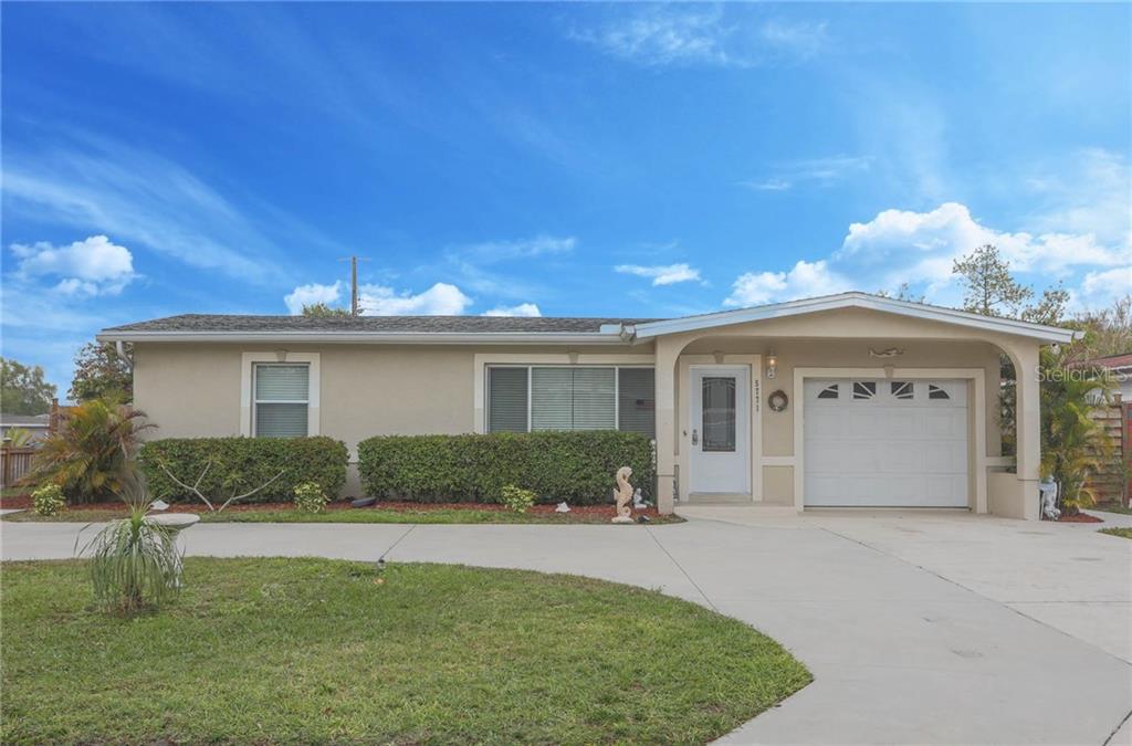 5771 Orange Road Seminole, FL 33772 - Photo 1 of 1 a front view of a house with a yard and garage