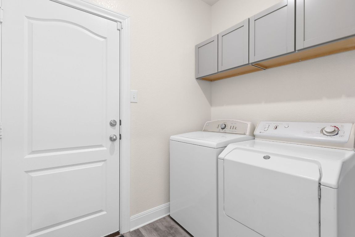 237 Benmyrtle Trail Georgetown, TX 78626 - Photo 19 of 22 Washroom with washer and clothes dryer, cabinet space, and wood finished floors