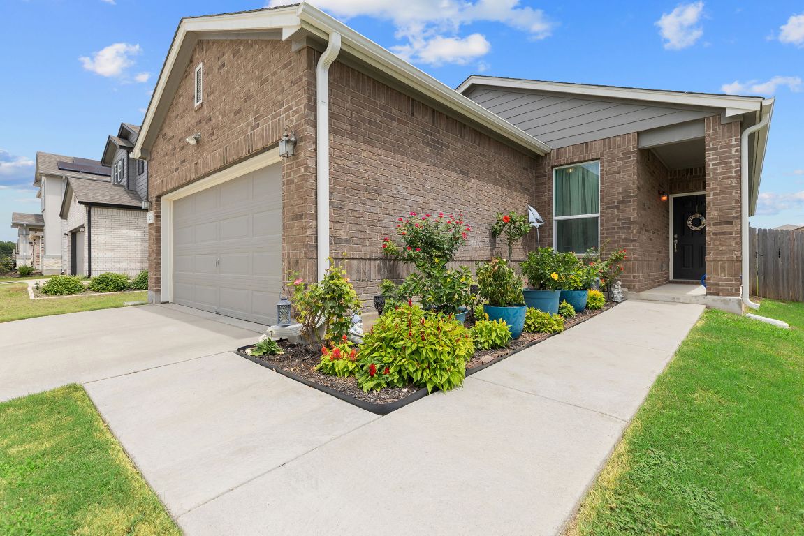 237 Benmyrtle Trail Georgetown, TX 78626 - Photo 2 of 22 Ranch-style home featuring concrete driveway, a garage, brick siding, and a front yard