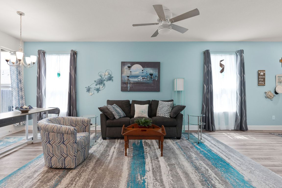 237 Benmyrtle Trail Georgetown, TX 78626 - Photo 4 of 22 Living area featuring wood finished floors, ceiling fan, and a chandelier