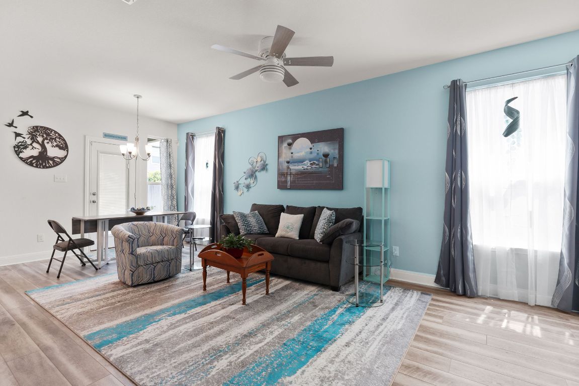 237 Benmyrtle Trail Georgetown, TX 78626 - Photo 5 of 22 Living room with wood finished floors, a chandelier, and ceiling fan