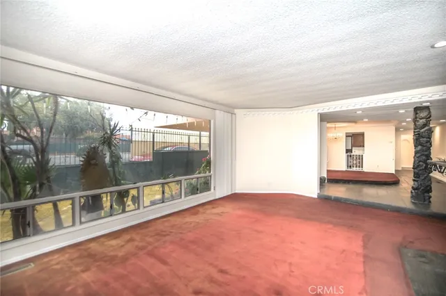 a large kitchen with stainless steel appliances kitchen island granite countertop a refrigerator and a sink