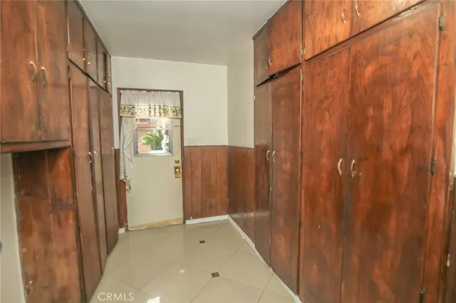 a bedroom with a bed and a refrigerator