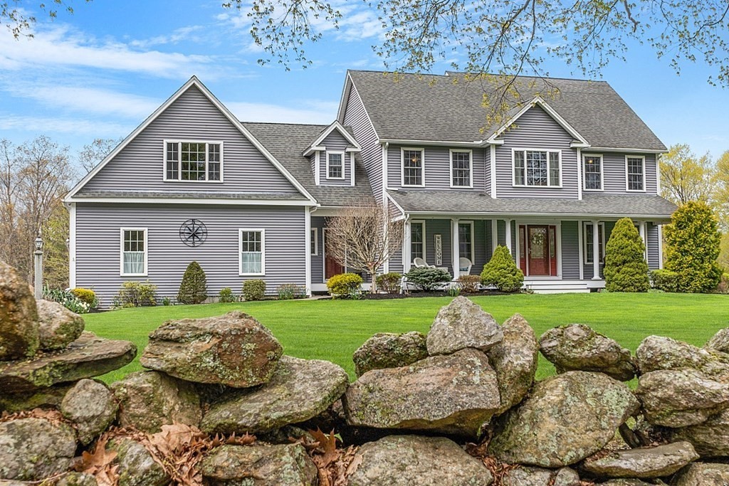 64 Walnut Street Rutland, MA 01543 - Photo 1 of 40 a front view of a house with a yard and garage
