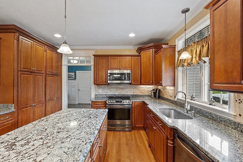 64 Walnut Street Rutland, MA 01543 - Photo 12 of 40 a kitchen with stainless steel appliances granite countertop a sink stove and refrigerator
