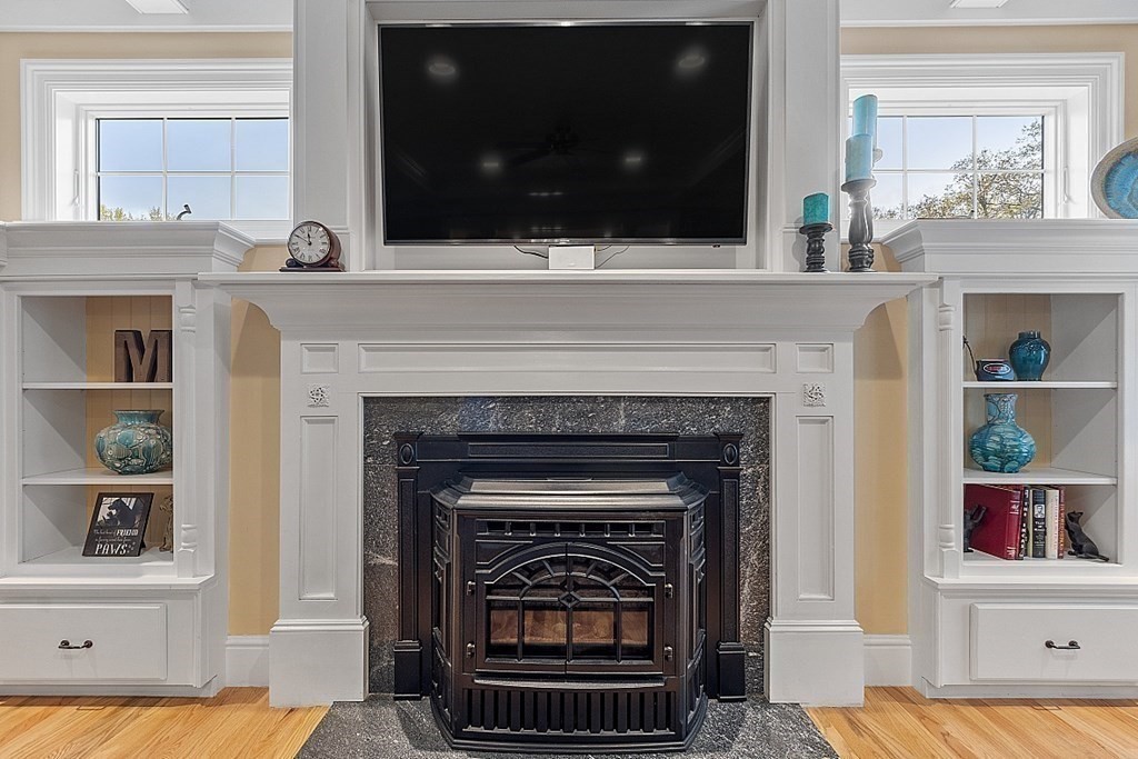 64 Walnut Street Rutland, MA 01543 - Photo 20 of 40 a living room with a fireplace and a flat screen tv