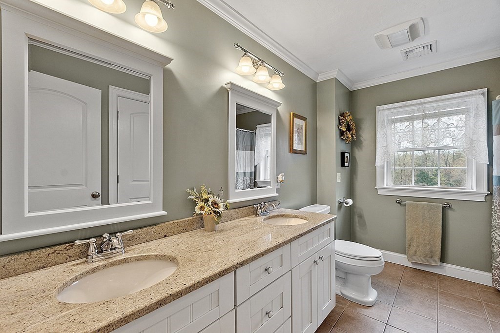 64 Walnut Street Rutland, MA 01543 - Photo 24 of 40 a bathroom with a granite countertop double vanity sink toilet and a mirror