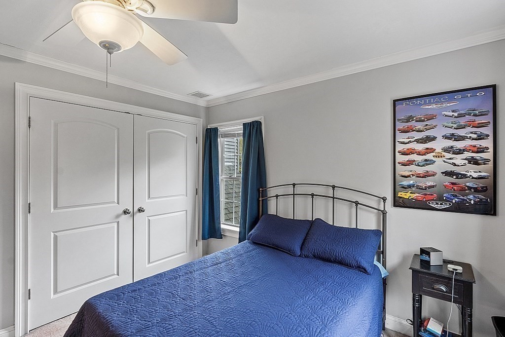 64 Walnut Street Rutland, MA 01543 - Photo 26 of 40 a bedroom with a large bed and a chandelier
