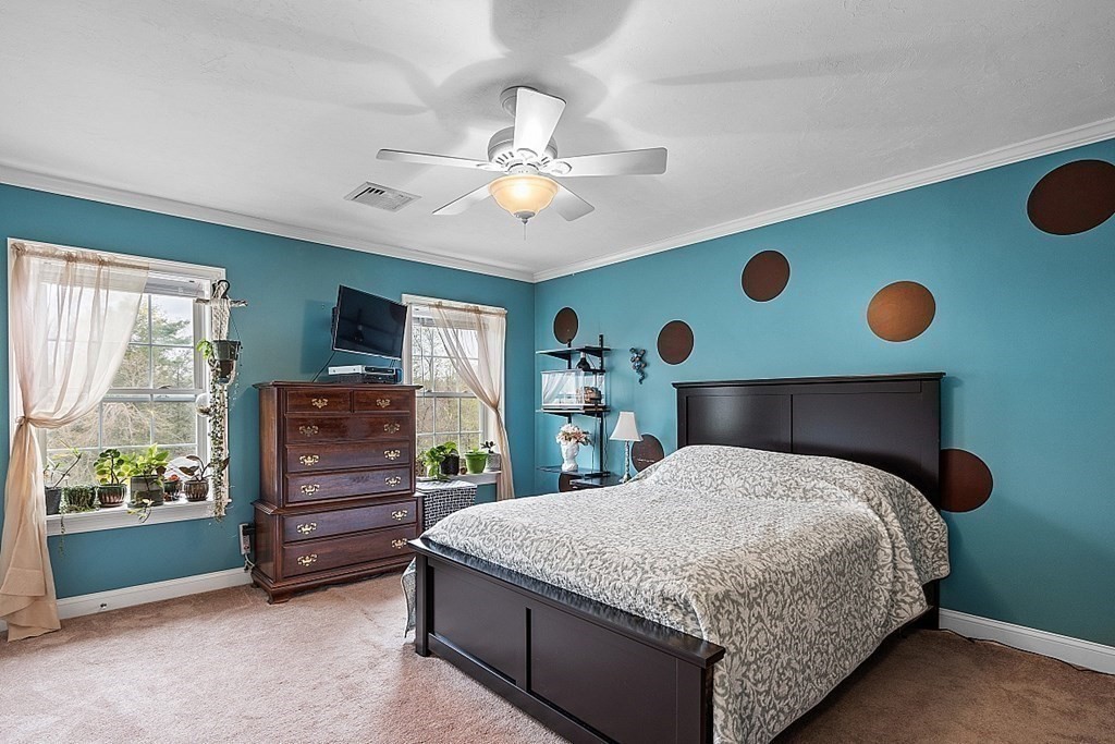 64 Walnut Street Rutland, MA 01543 - Photo 27 of 40 a bedroom with a bed and a chandelier