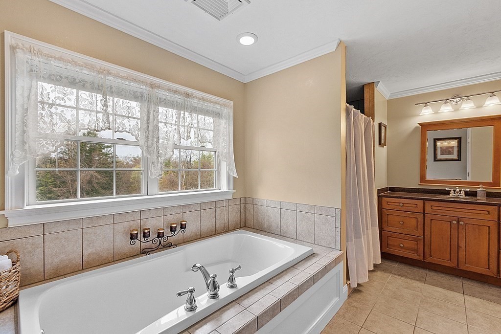 64 Walnut Street Rutland, MA 01543 - Photo 28 of 40 a bathroom with a tub sink and mirror