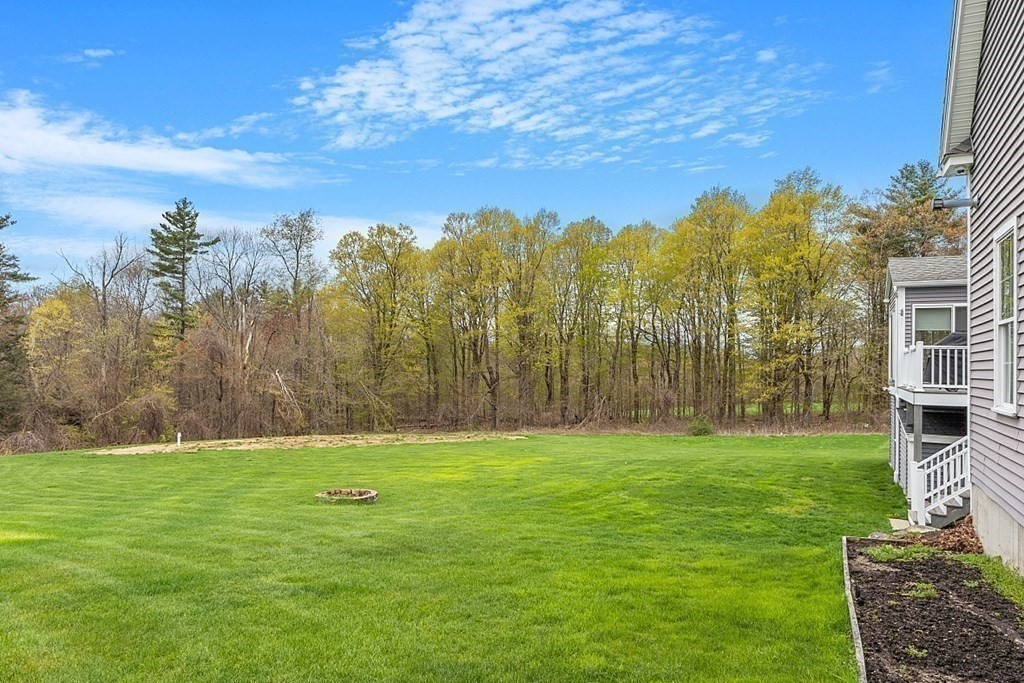 64 Walnut Street Rutland, MA 01543 - Photo 39 of 40 a view of a yard with a building in the background