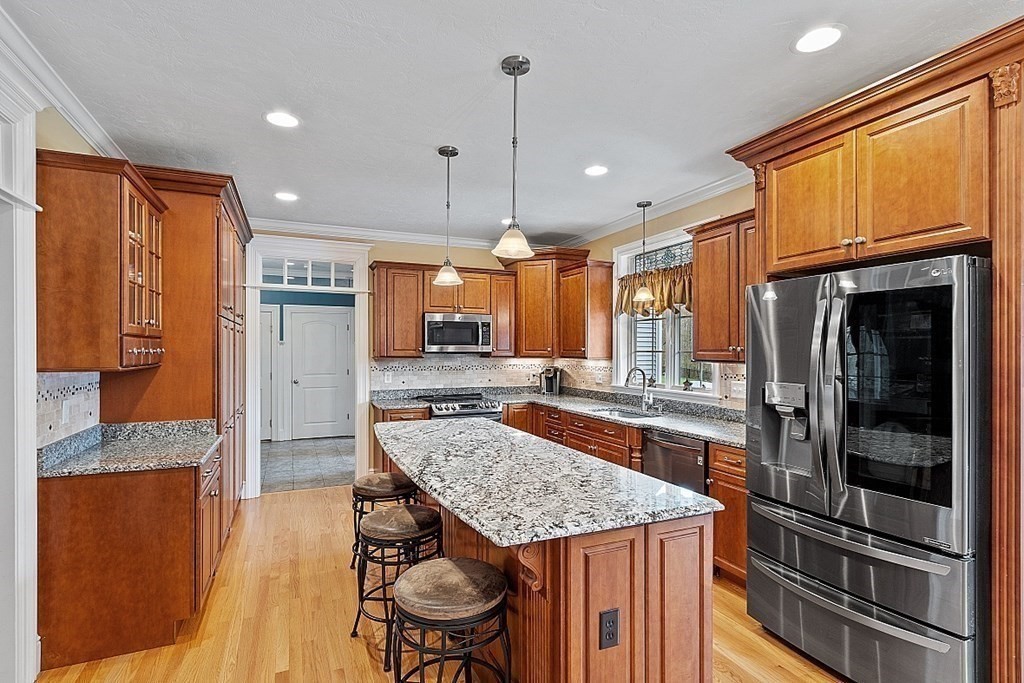 64 Walnut Street Rutland, MA 01543 - Photo 9 of 40 a kitchen with stainless steel appliances granite countertop a stove and a refrigerator