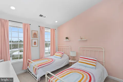 a bedroom with bed and a window