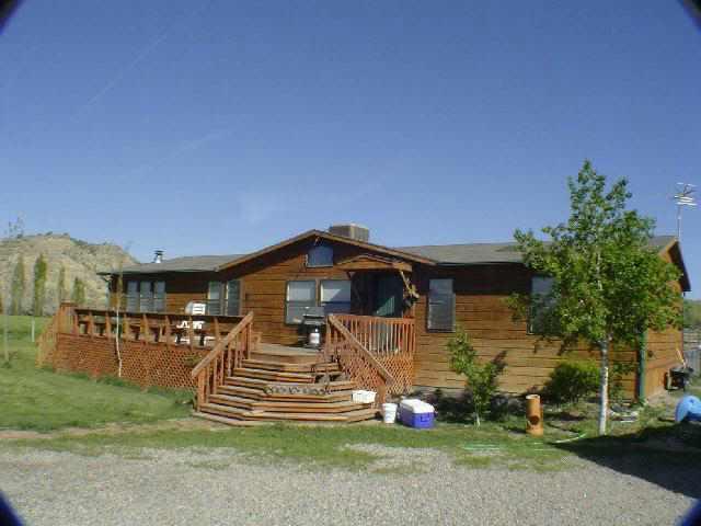 810 223rd Road Rifle, CO 81650 - Photo 1 of 9 a front view of a house with a yard
