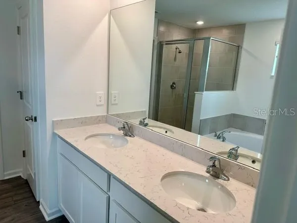a bathroom with a double vanity sink and a mirror