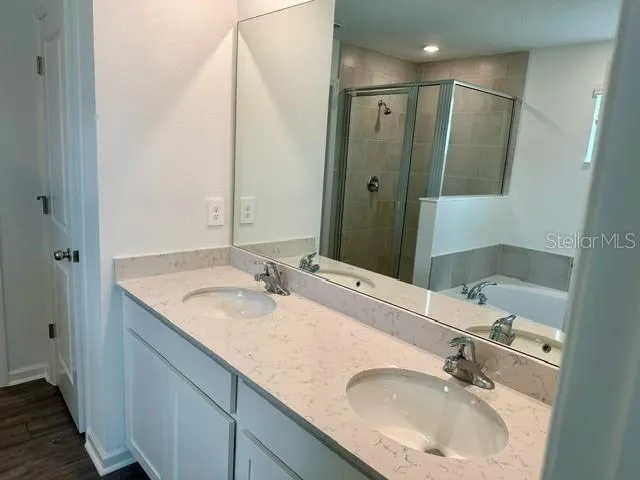 a bathroom with a double vanity sink and a mirror