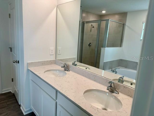4734 Southwest 83rd Loop Ocala, FL 34476 - Photo 11 of 28 a bathroom with a double vanity sink and a mirror