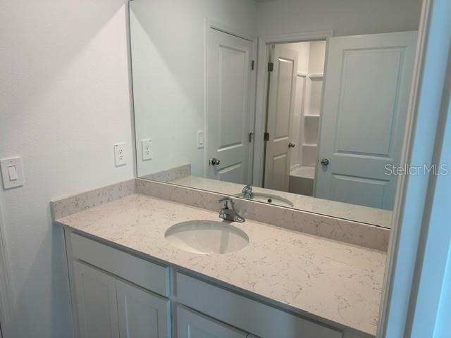 4734 Southwest 83rd Loop Ocala, FL 34476 - Photo 18 of 28 a bathroom with a sink vanity granite and a mirror