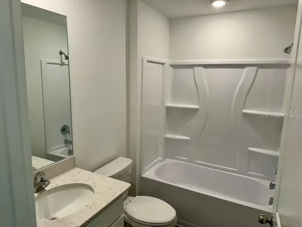 a bathroom with a sink toilet and bathtub