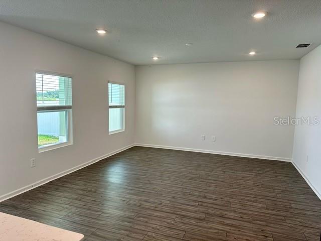 4734 Southwest 83rd Loop Ocala, FL 34476 - Photo 6 of 28 an empty room with wooden floor and windows