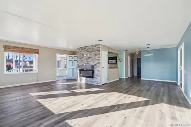 an empty room with fireplace and windows