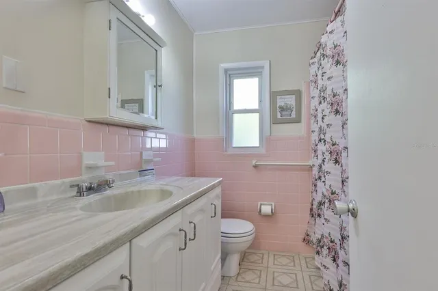 a bathroom with a sink a vanity and a toilet