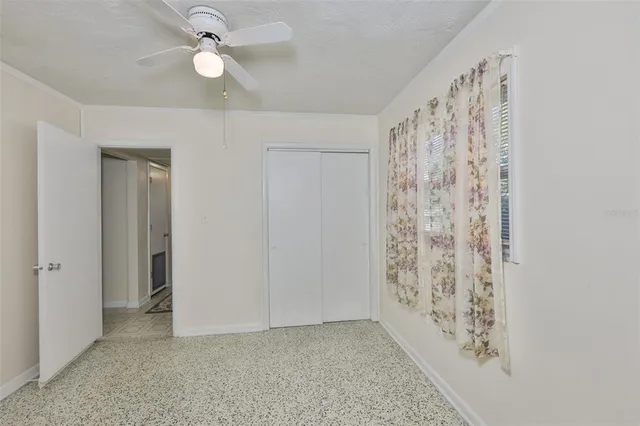 a view of entryway with window and a ceiling fan