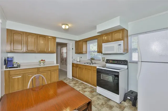 a kitchen with a sink stove and refrigerator