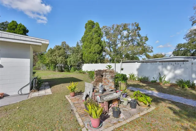 an outdoor sitting area with furniture and a yard