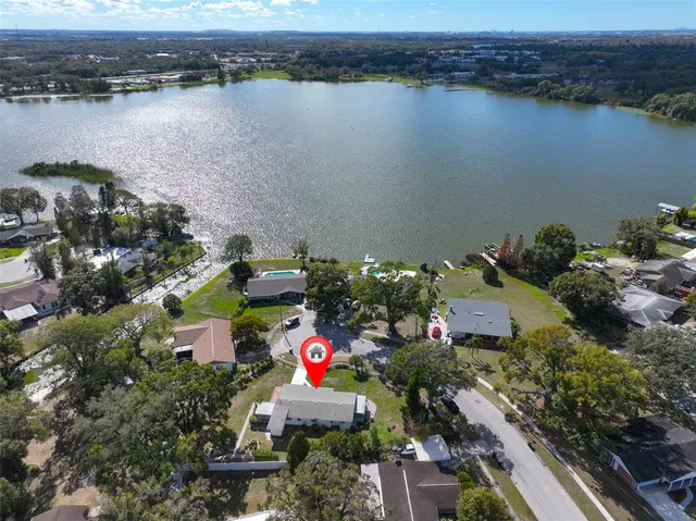 an aerial view of a house with a lake view